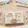 Pastel blog banner titled Junk Journaling for Beginners. Shows an open journal with a plush bear and ephemera, surrounded by pens, tape, and stickers.